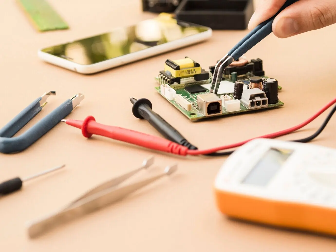 Applying pliers to a circuit board.